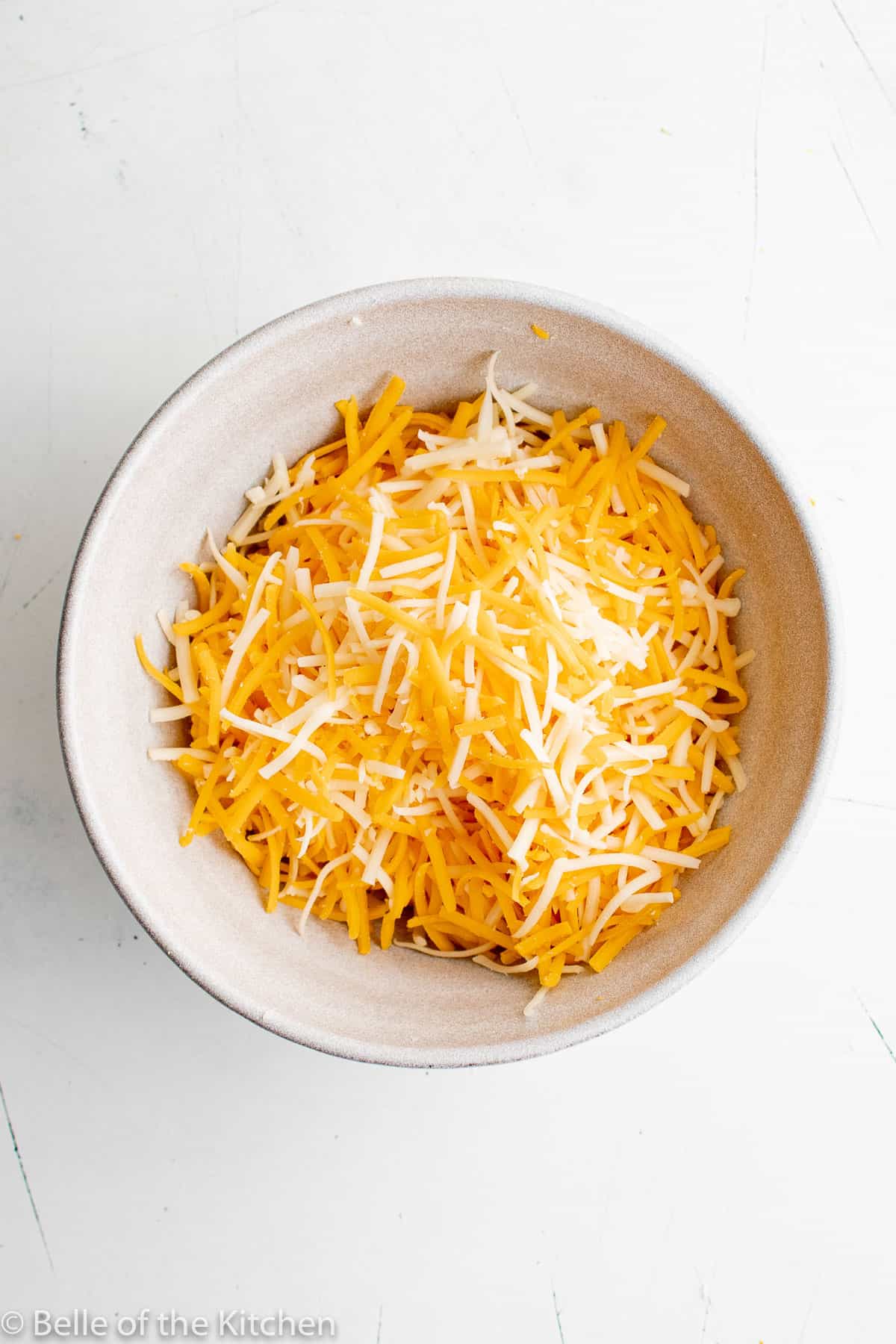 a bowl full of shredded cheese.