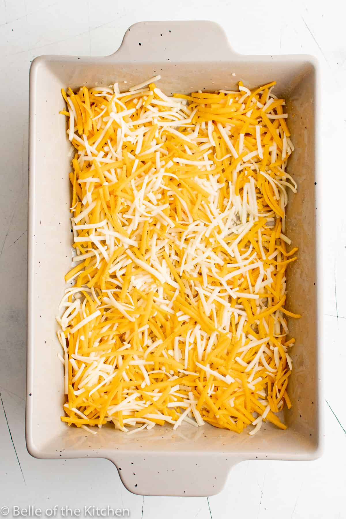 a baking dish full of cheese.