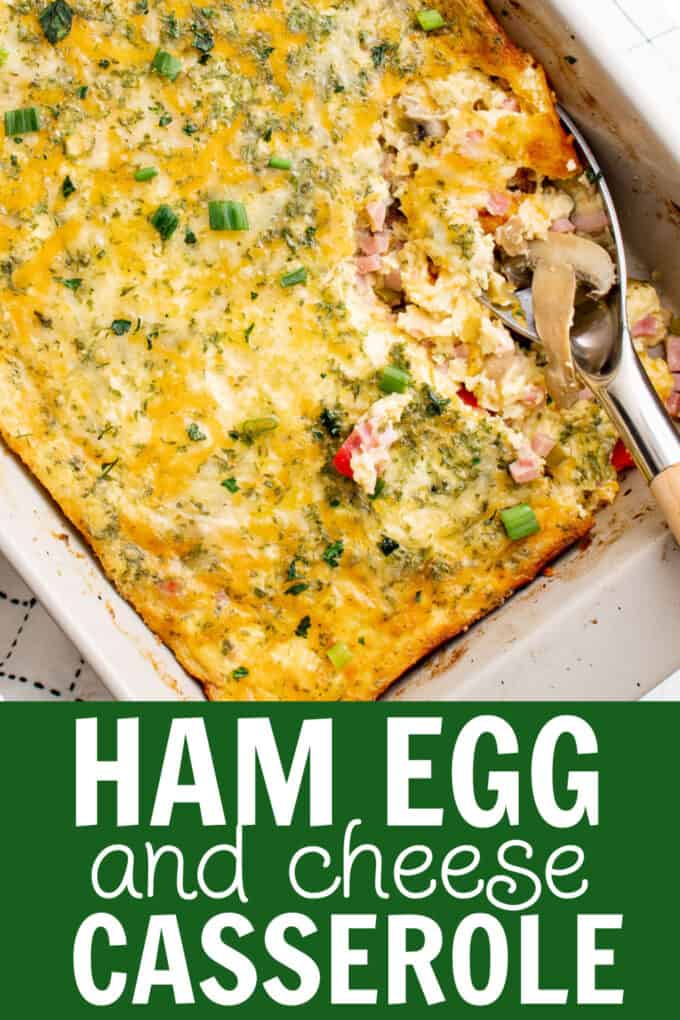 a baking dish full of ham egg and cheese casserole with a spoon dug into it.
