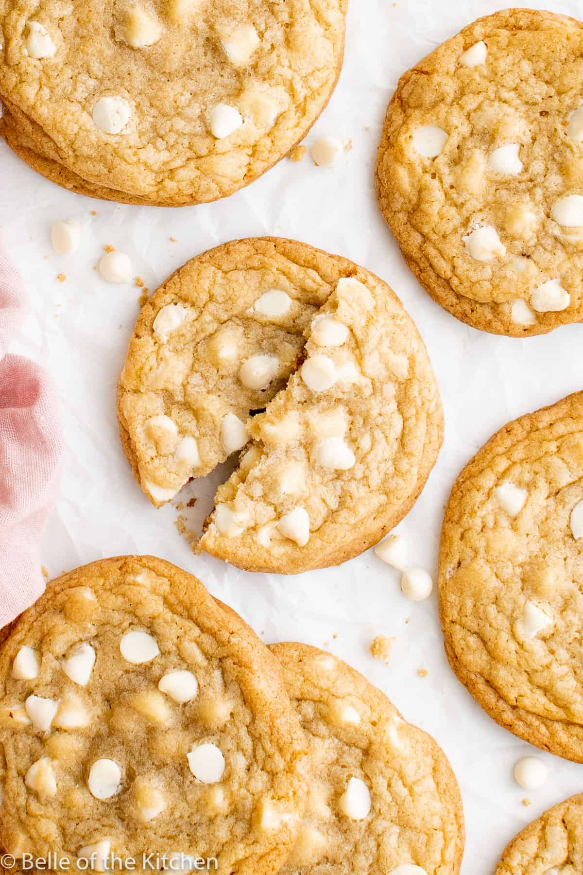 a white chocolate chip cookie split in half.