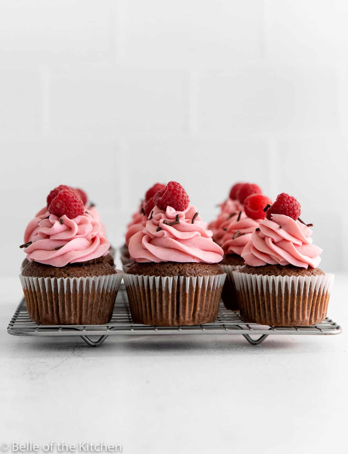 chocolate raspberry cupcakes on a wire rack.