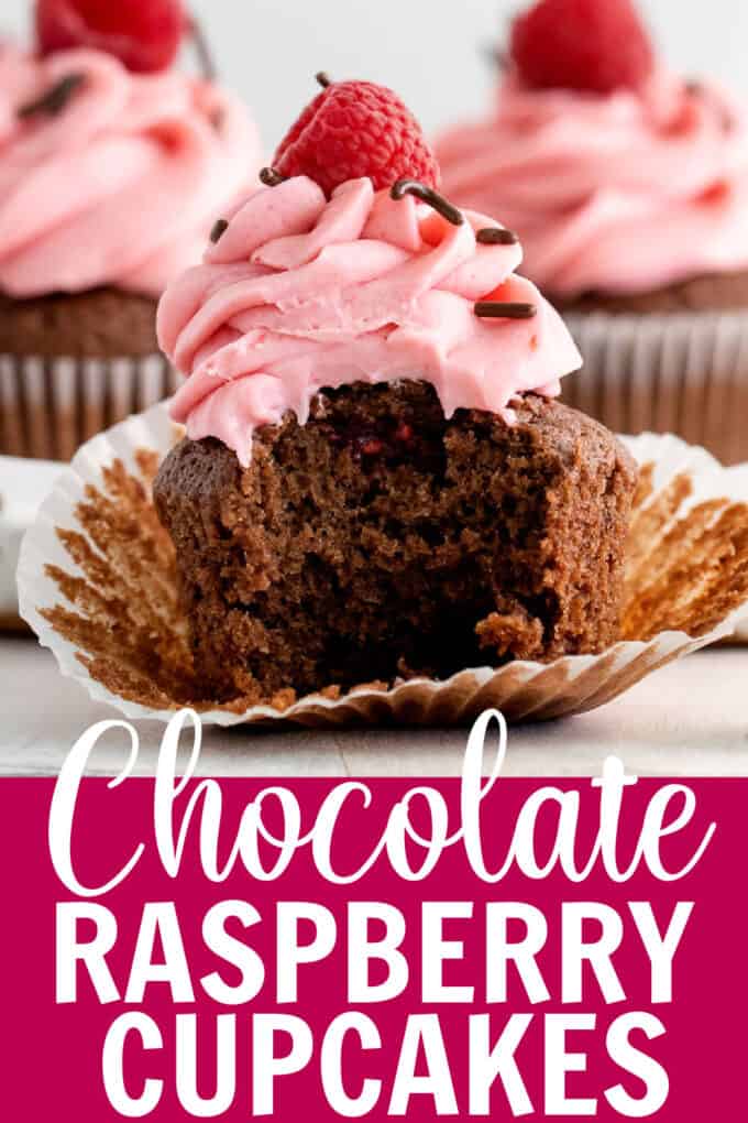 a chocolate raspberry cupcake with a bite taken out.