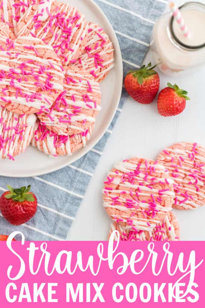 strawberry cookies on a plate with fresh strawberries beside it.