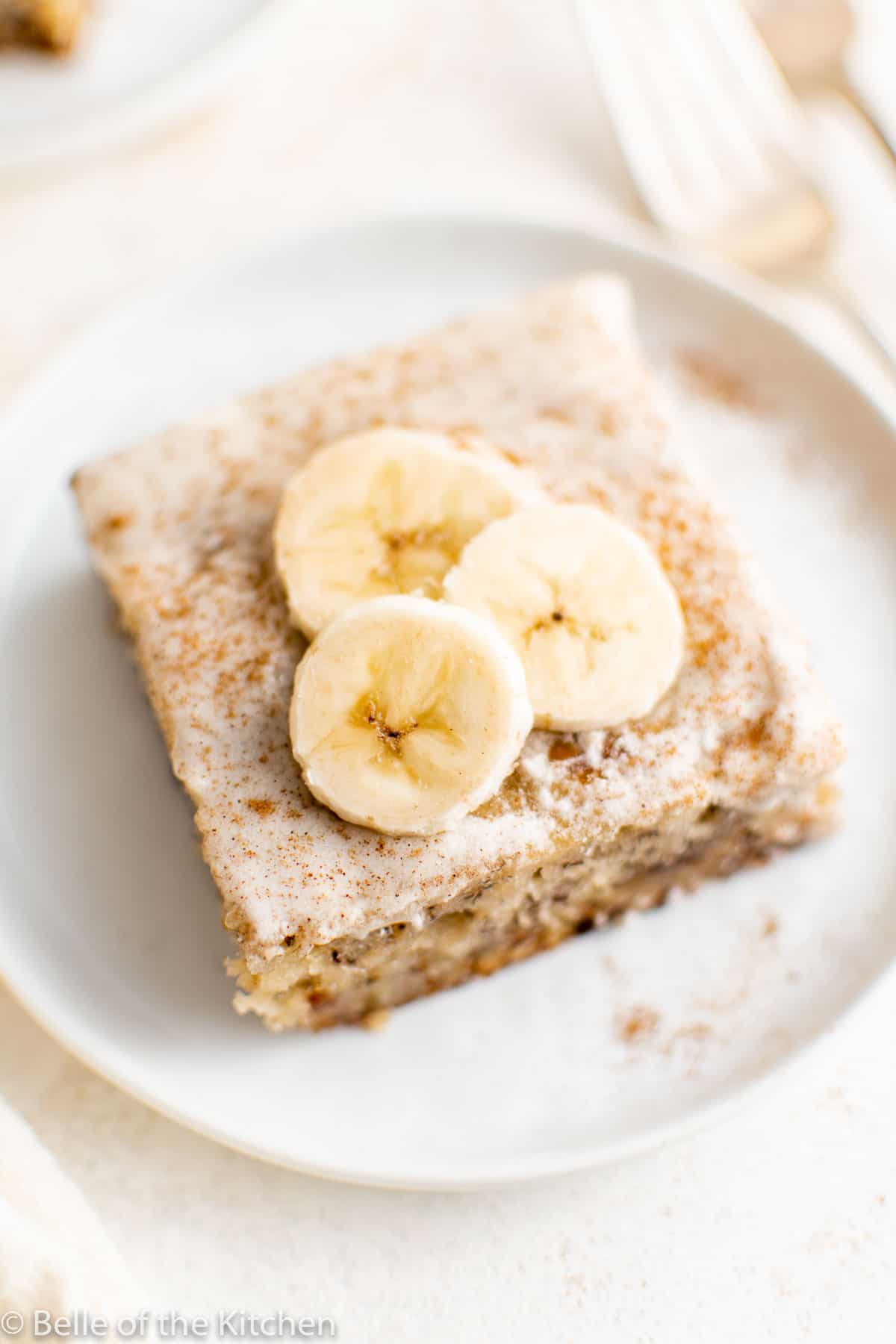 a slice of banana cake on a white plate.