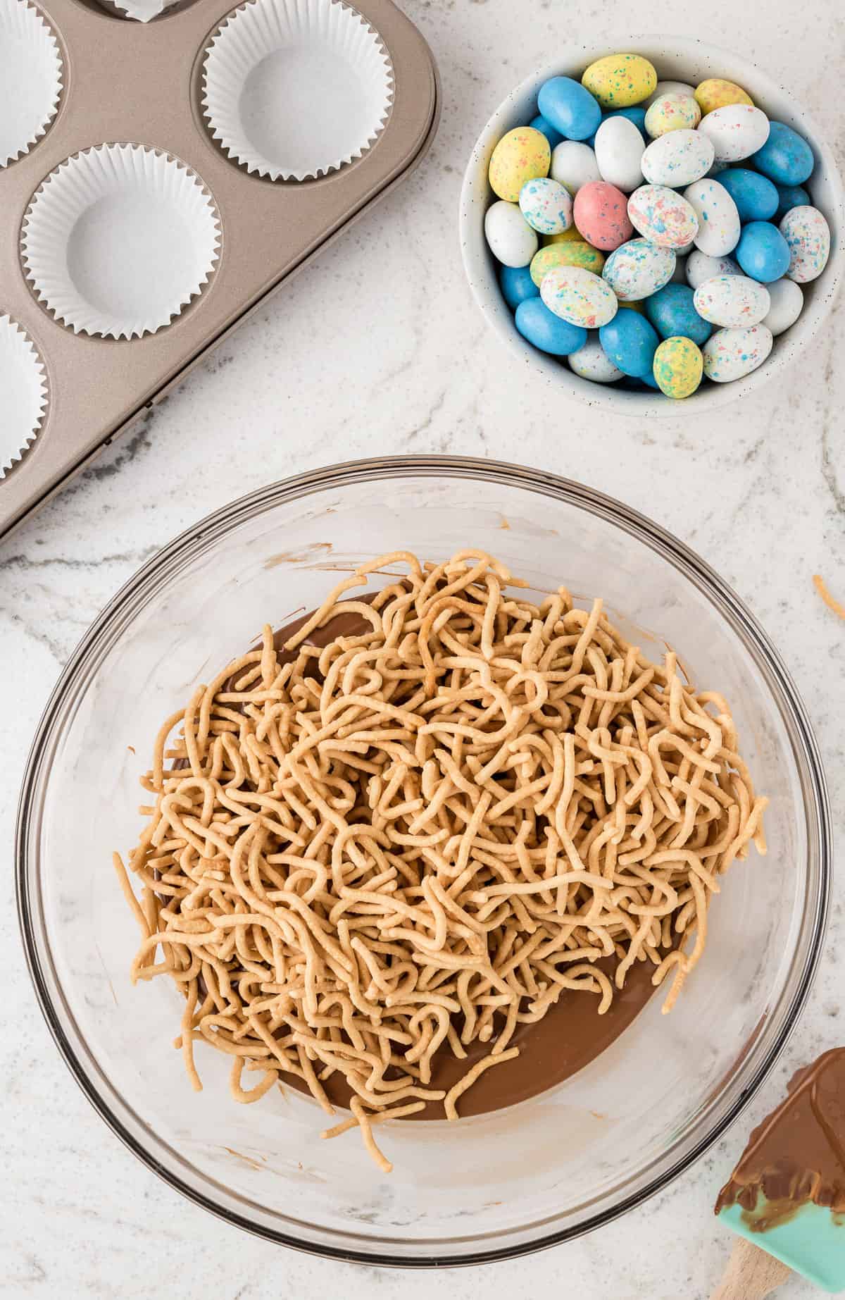 a bowl of chow mein noodles and chocolate.