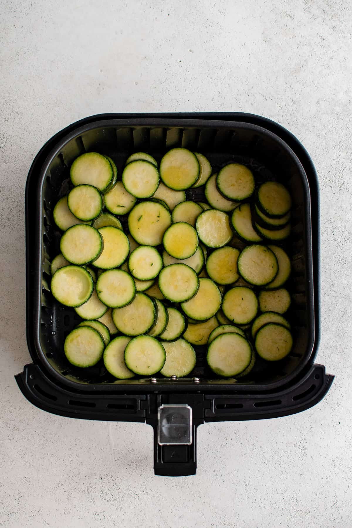 sliced and cooked zucchini in the air fryer.