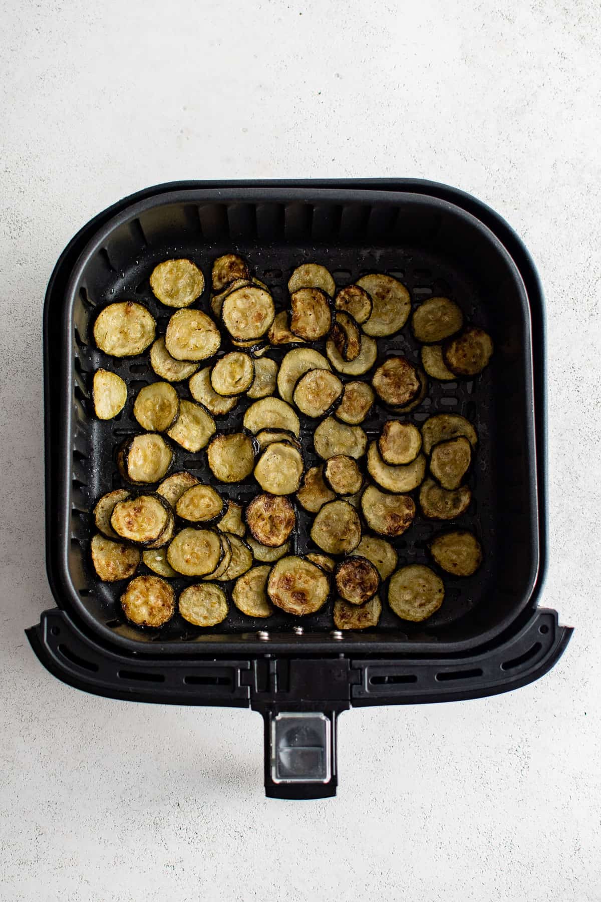 sliced and cooked zucchini in the air fryer.