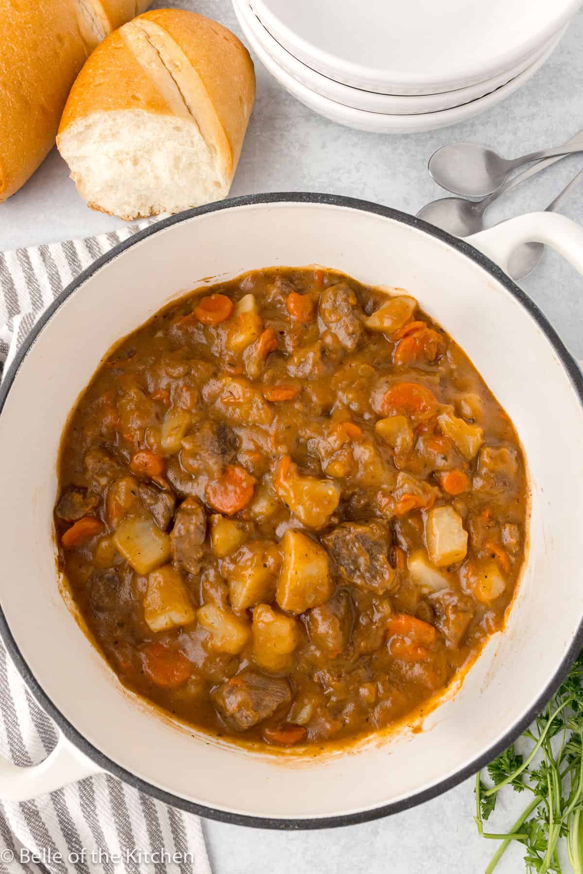 a large pot of stew with beef, carrots, and potatoes.