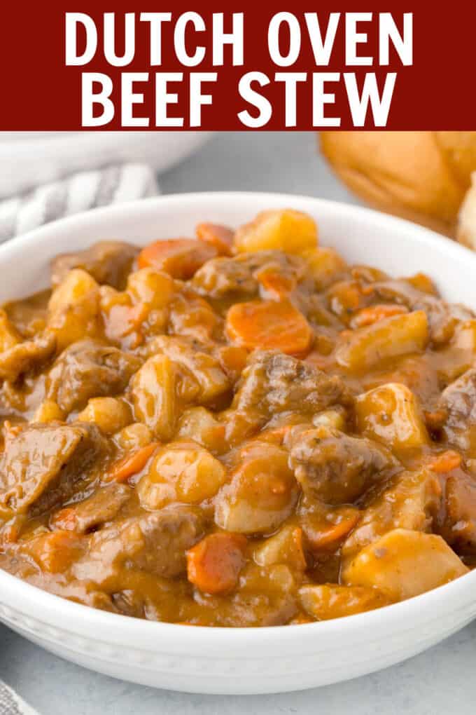 a white bowl filled with beef stew including carrots, beef, and gravy.