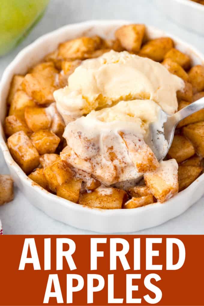 a spoon digging into fried apples with ice cream on top.