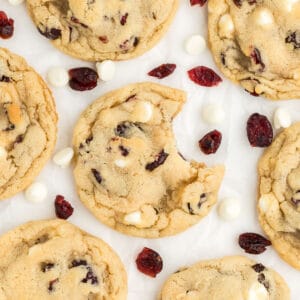 an overhead shot of cranberry white chocolate cookies on a counter top.