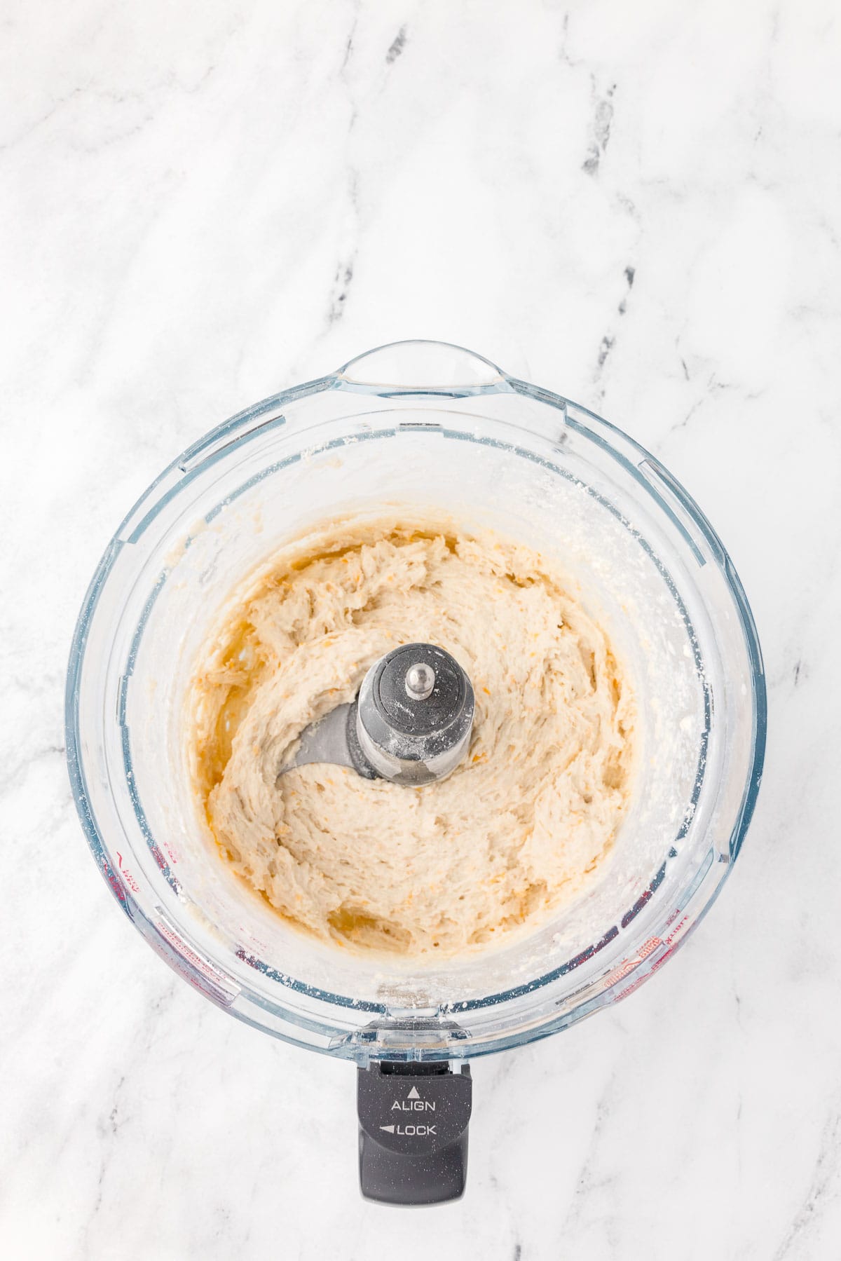 a food processor with biscuit dough inside.