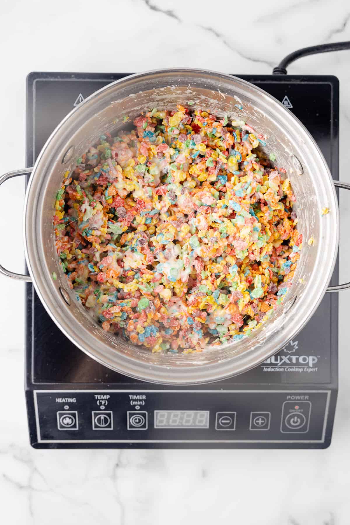 Fruity Pebble mixture in a pan.