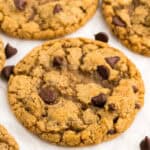 a pumpkin chocolate chip cookie on a white counter top.