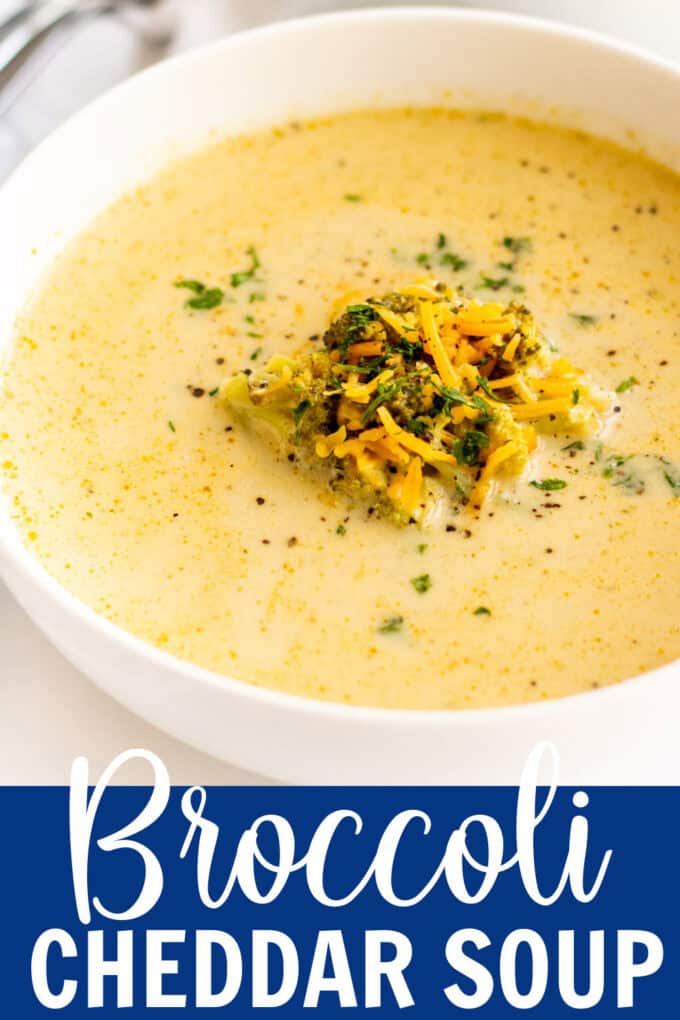 A white bowl of broccoli cheddar soup.