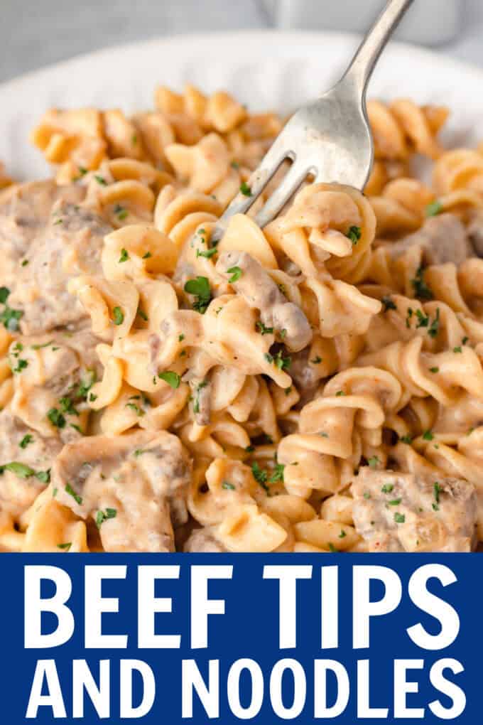 Egg noodles with beef on a plate with a fork scooping into it.