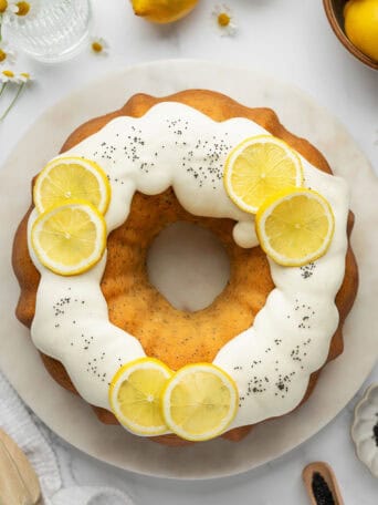 A lemon bundt cake on a white plate.