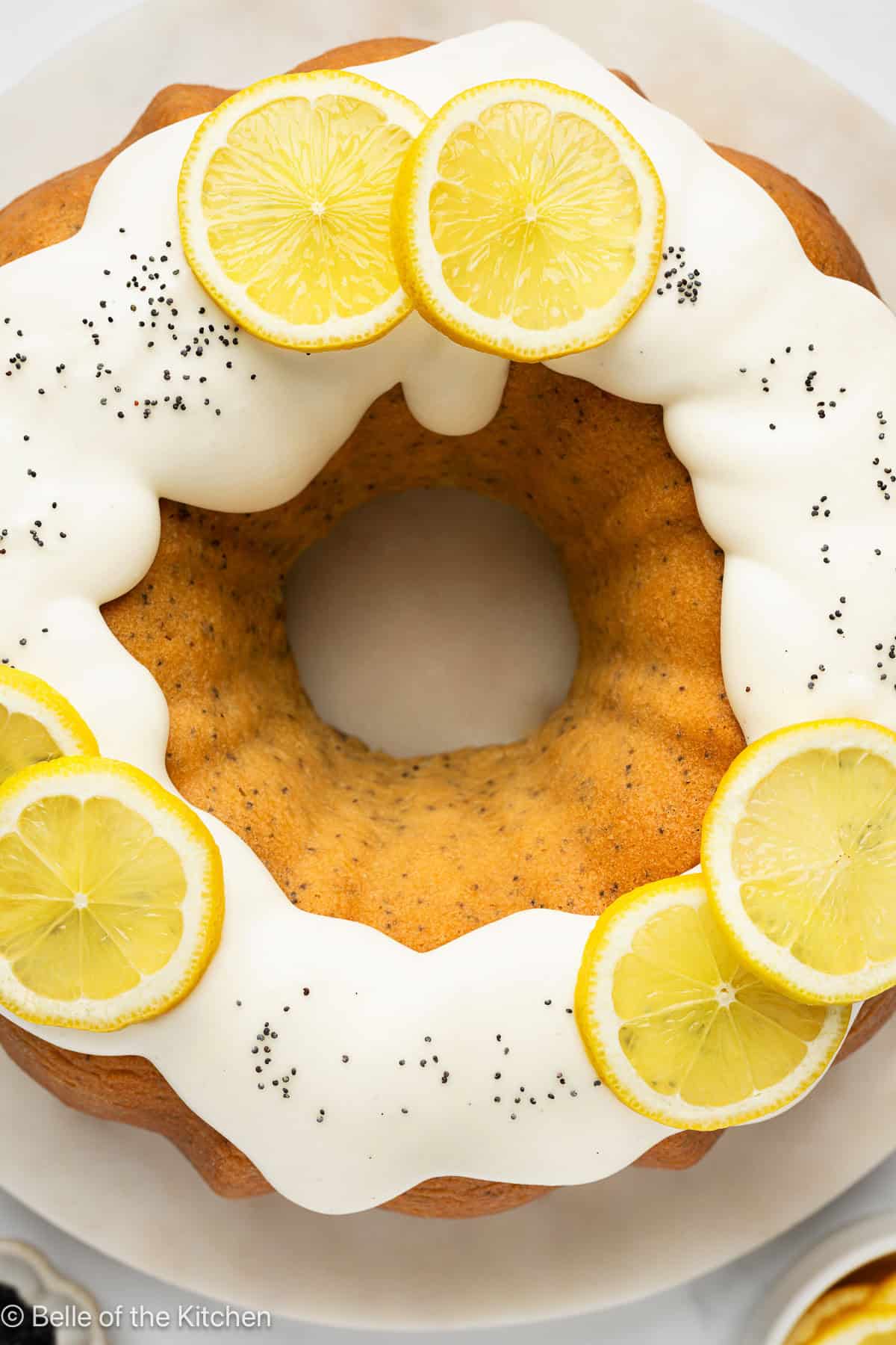 A lemon bundt cake on a white plate.