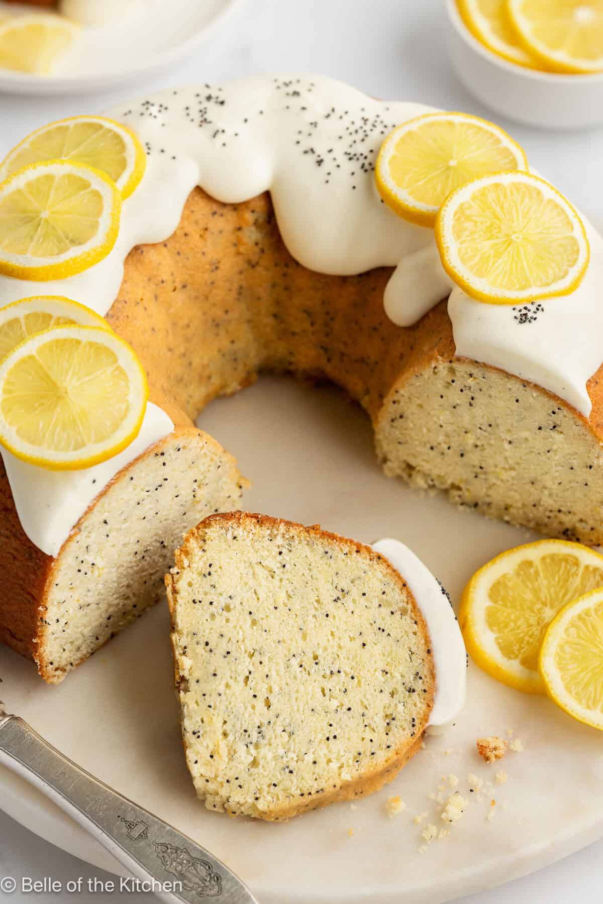 Slices of lemon bundt cake on a cake stand.