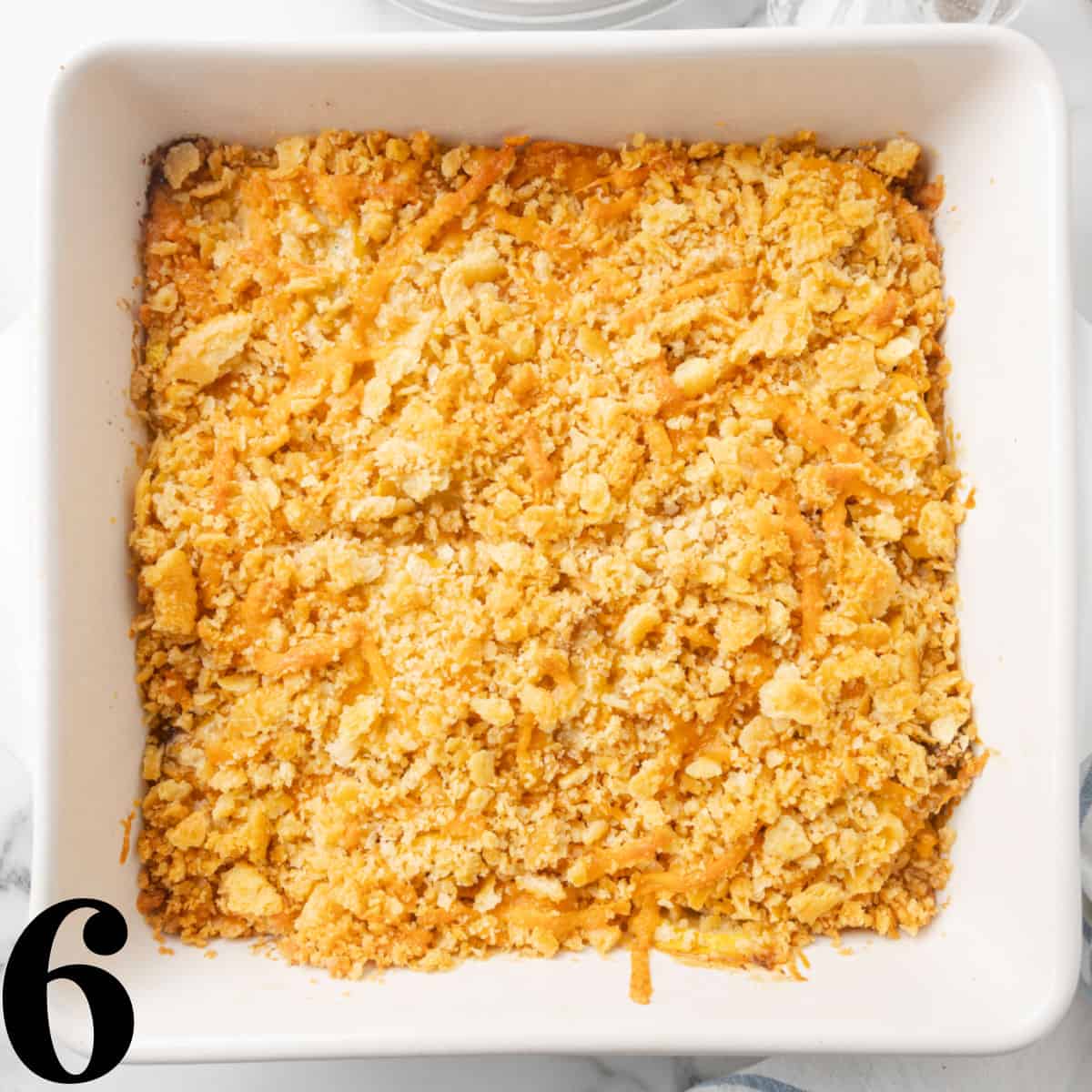 A casserole dish of squash casserole with cracker topping.