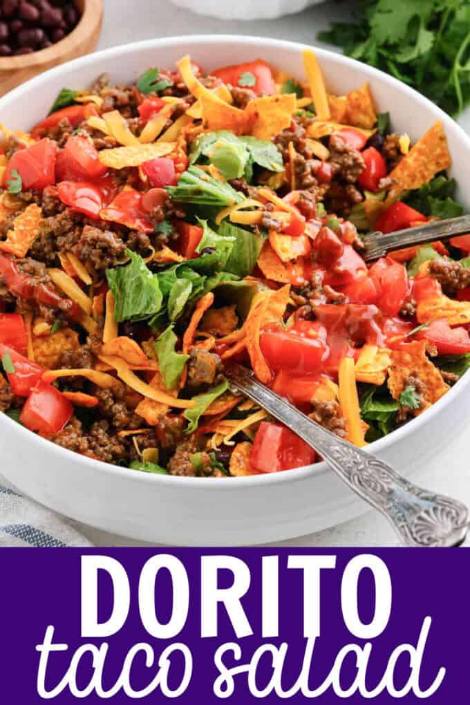 A white bowl of taco salad with Nacho Doritos.