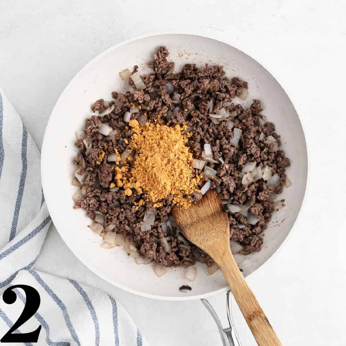 Ground beef in a skillet with taco seasoning.