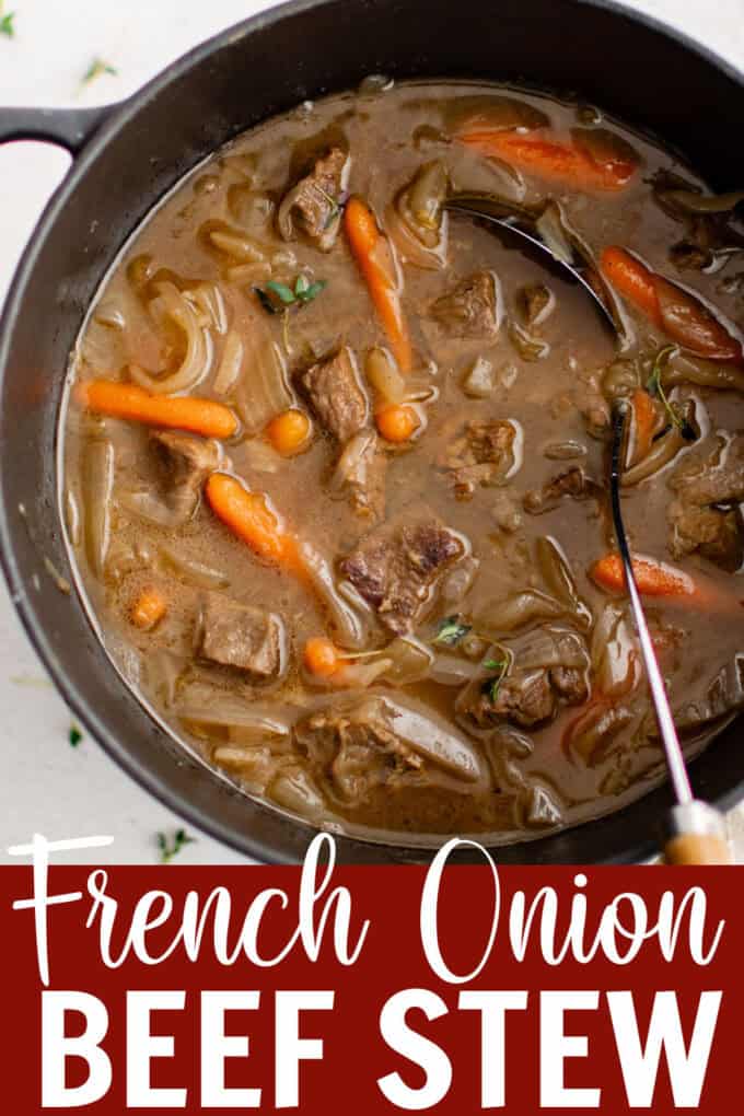 A large pot full of beef stew with carrots.