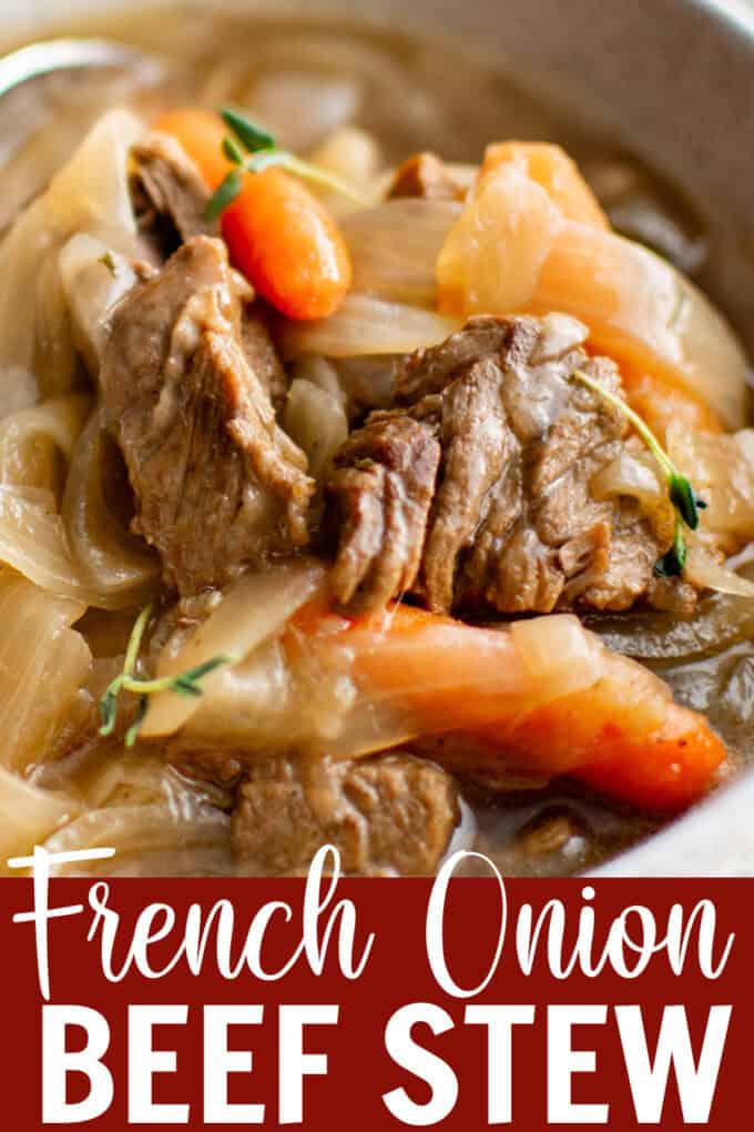 A large pot full of beef stew with carrots.