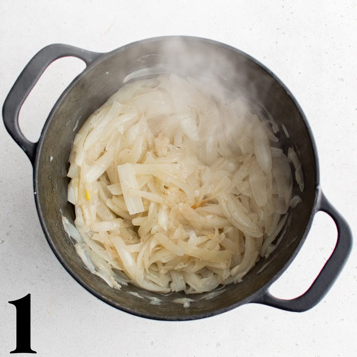 A pot full of cooked onions.