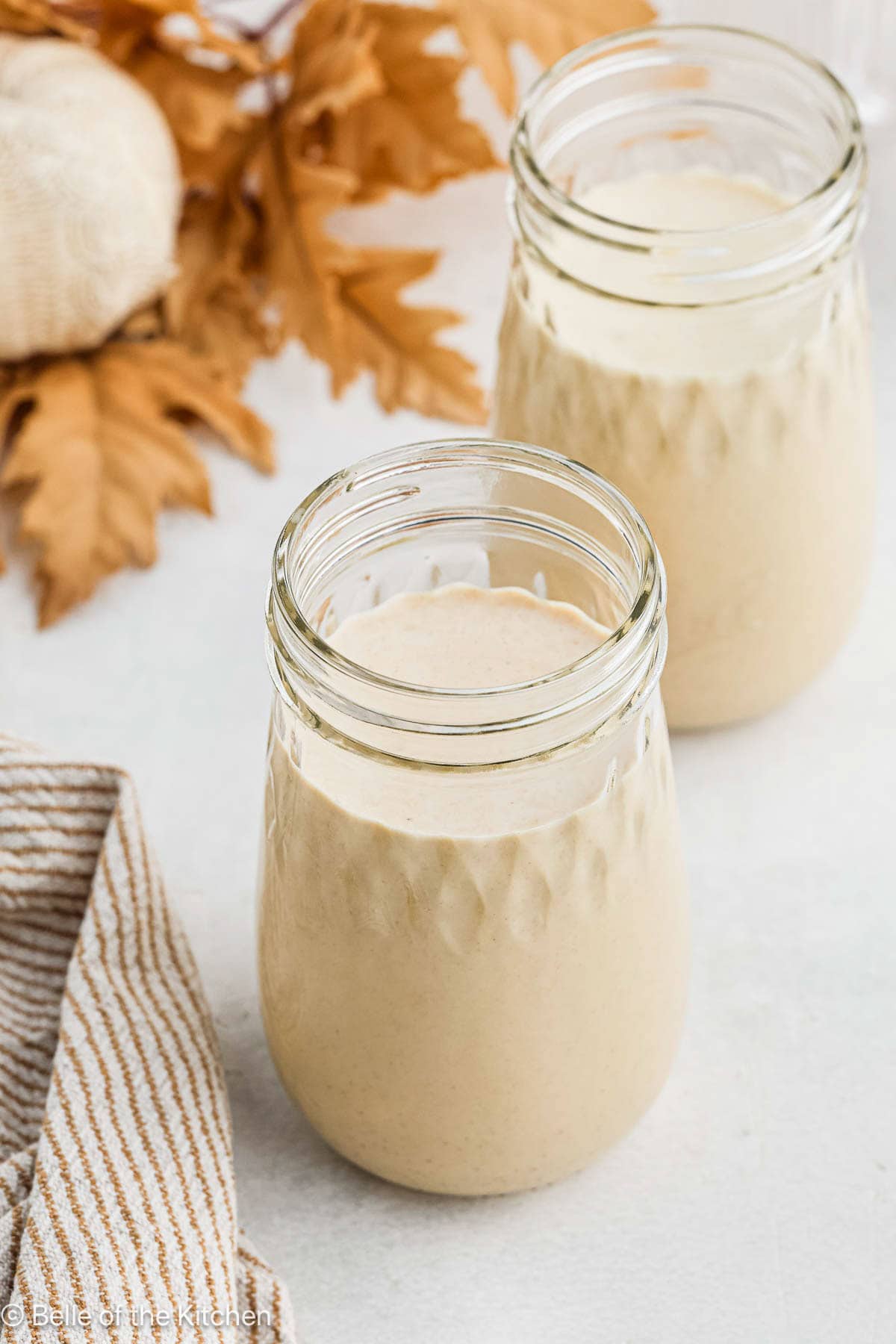 Decorative mason jars full of pumpkin coffee creamer.