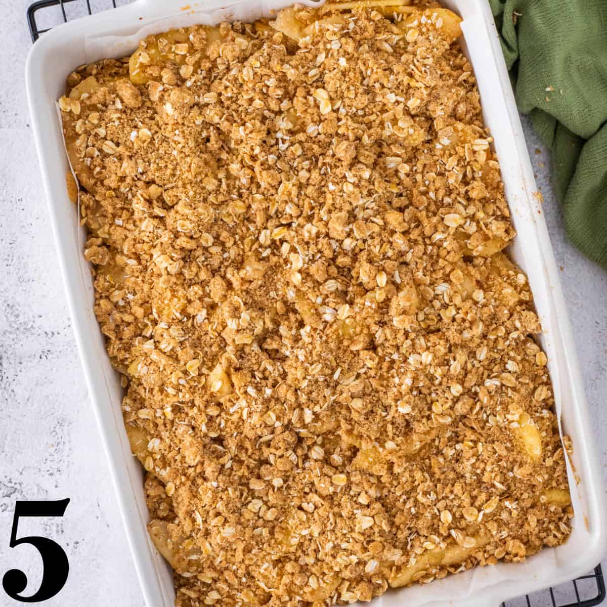 A white baking dish full of apple pie bars.