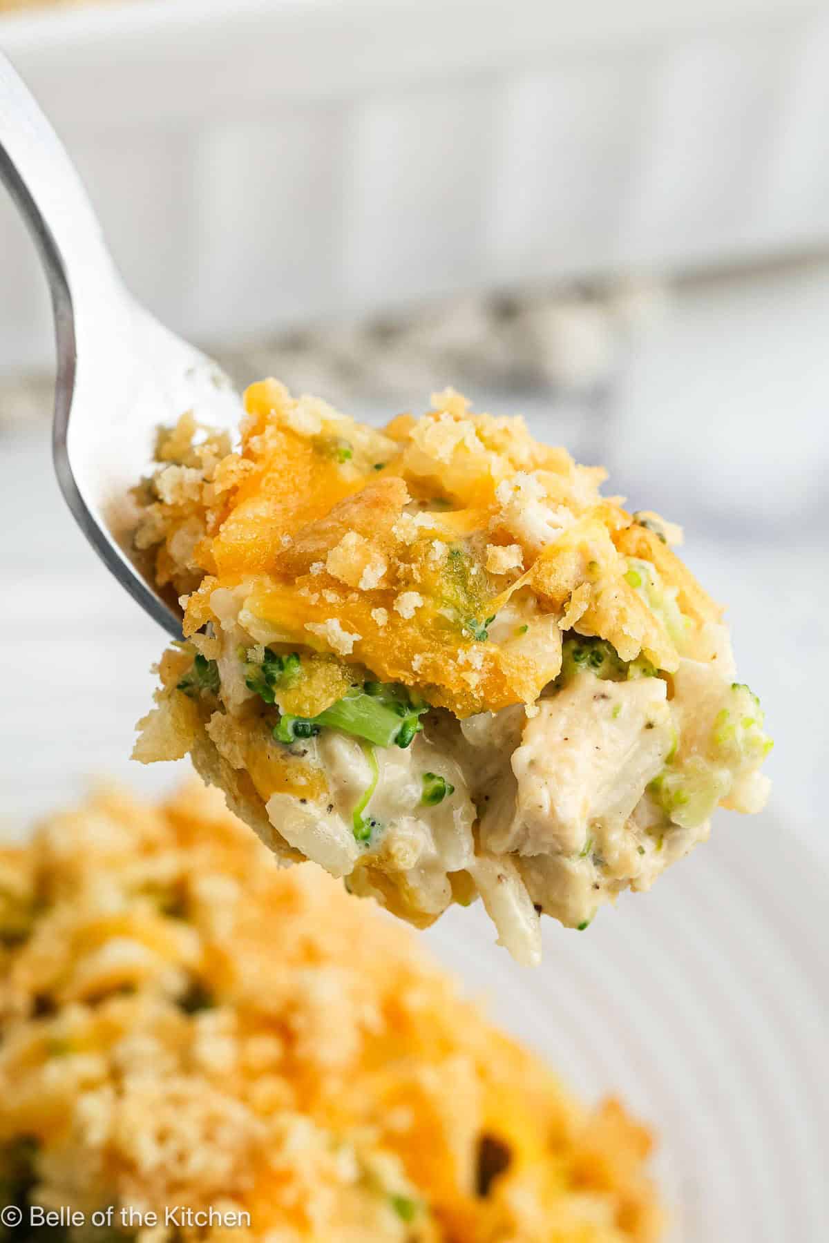 A fork scooping up chicken broccoli rice casserole.