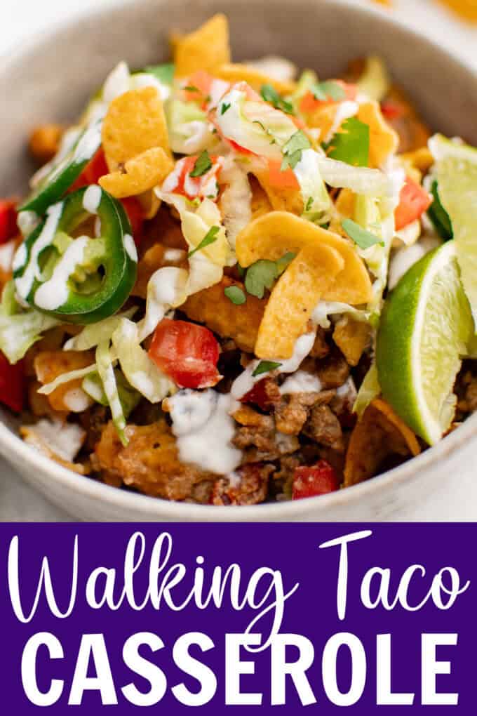 A bowl of taco meat with lettuce, black beans, cheese, tomatoes, and jalapenos.