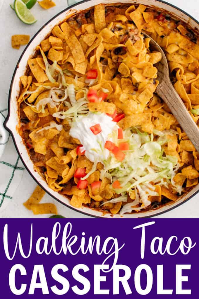 A skillet full of taco meat topped with Fritos.