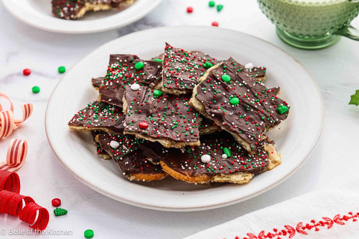 A stack of christmas crack (toffee) on a white plate.