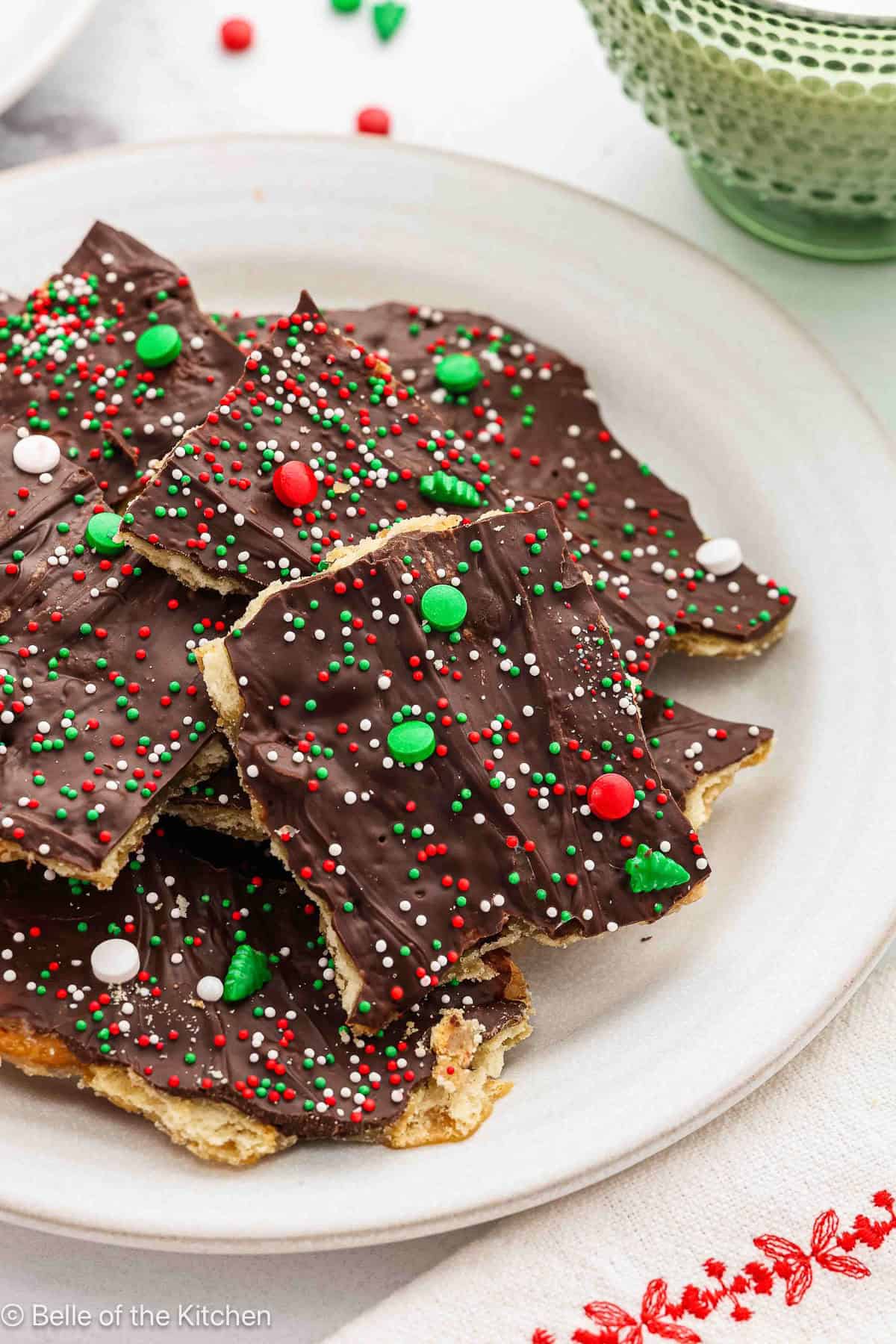 A stack of christmas crack (toffee) on a white plate.