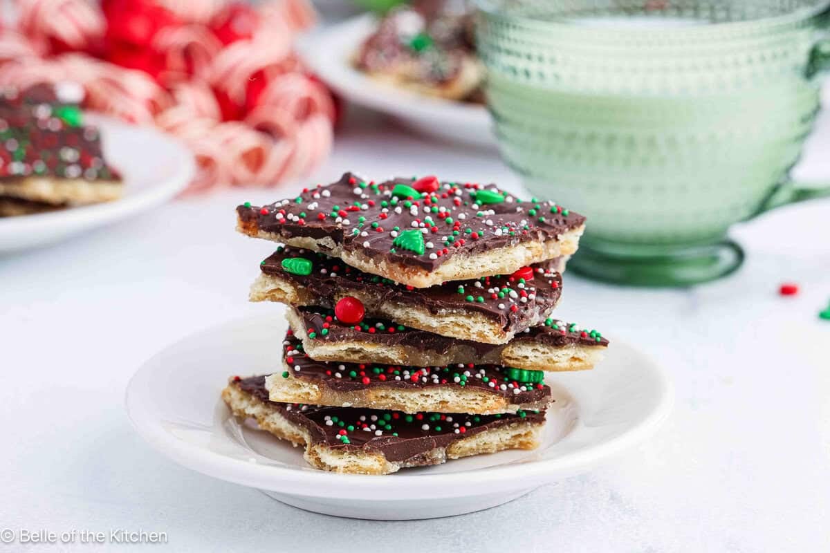 A stack of christmas crack (toffee) on a white plate.