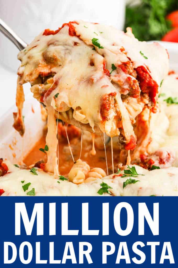 A spoon scooping up baked pasta from a baking dish.