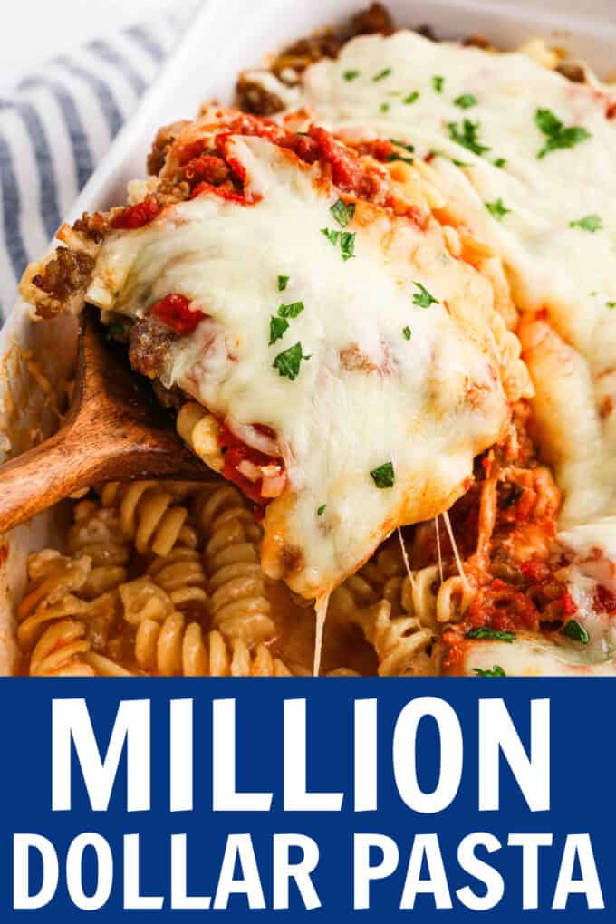 A spoon scooping up baked pasta from a baking dish.