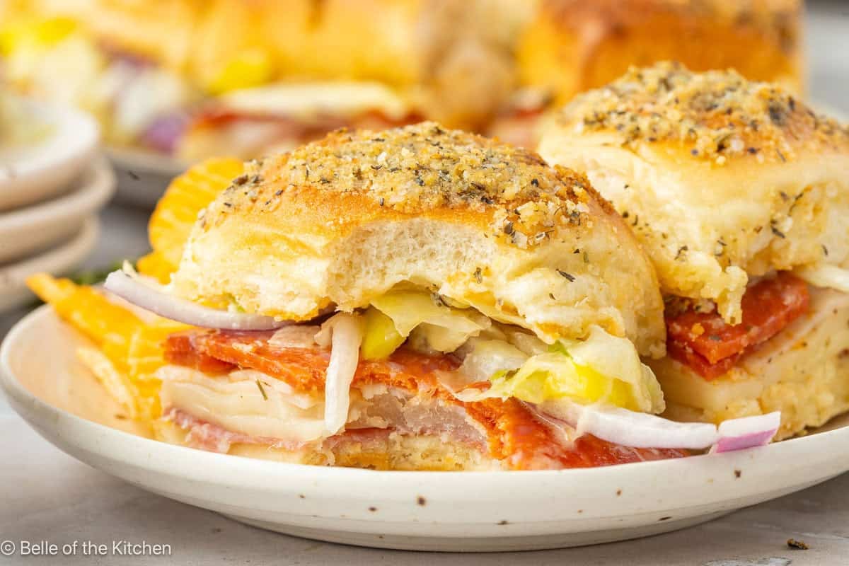 A close up of a slider sandwich with a bite taken out.