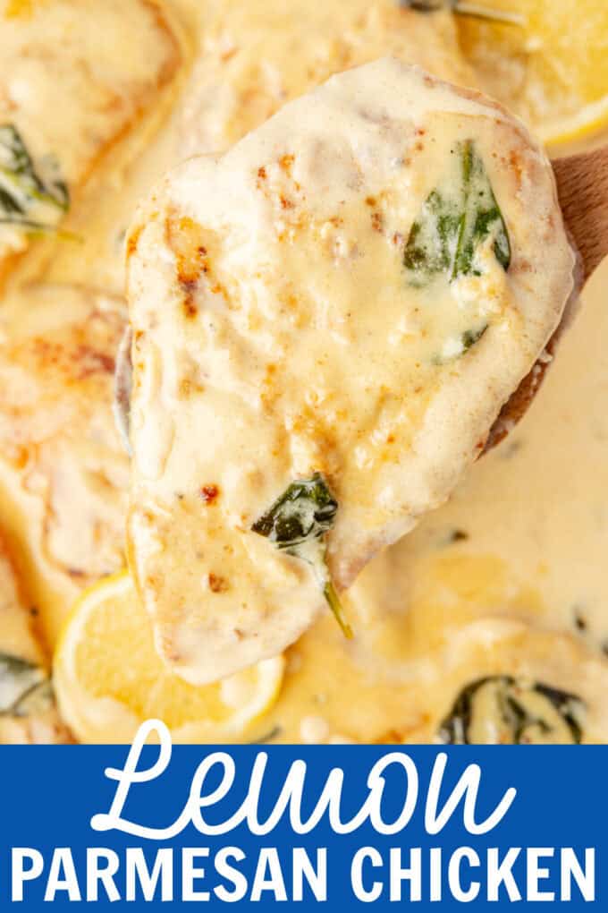 A wooden spoon holding a chicken breast out of a skillet.