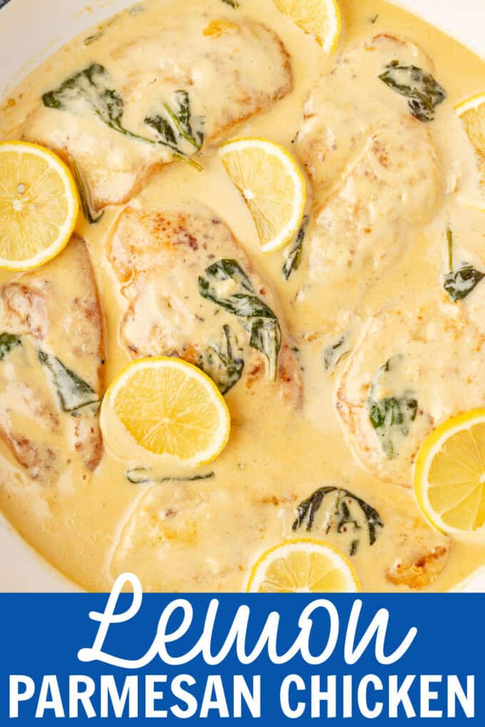 A skillet full of chicken in a lemon sauce with sliced lemons.