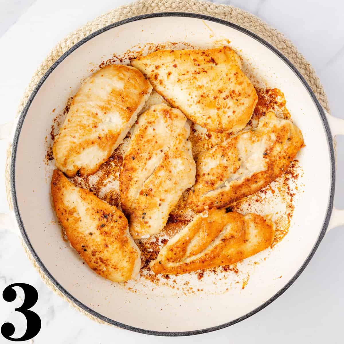 A skillet full of cooked chicken.