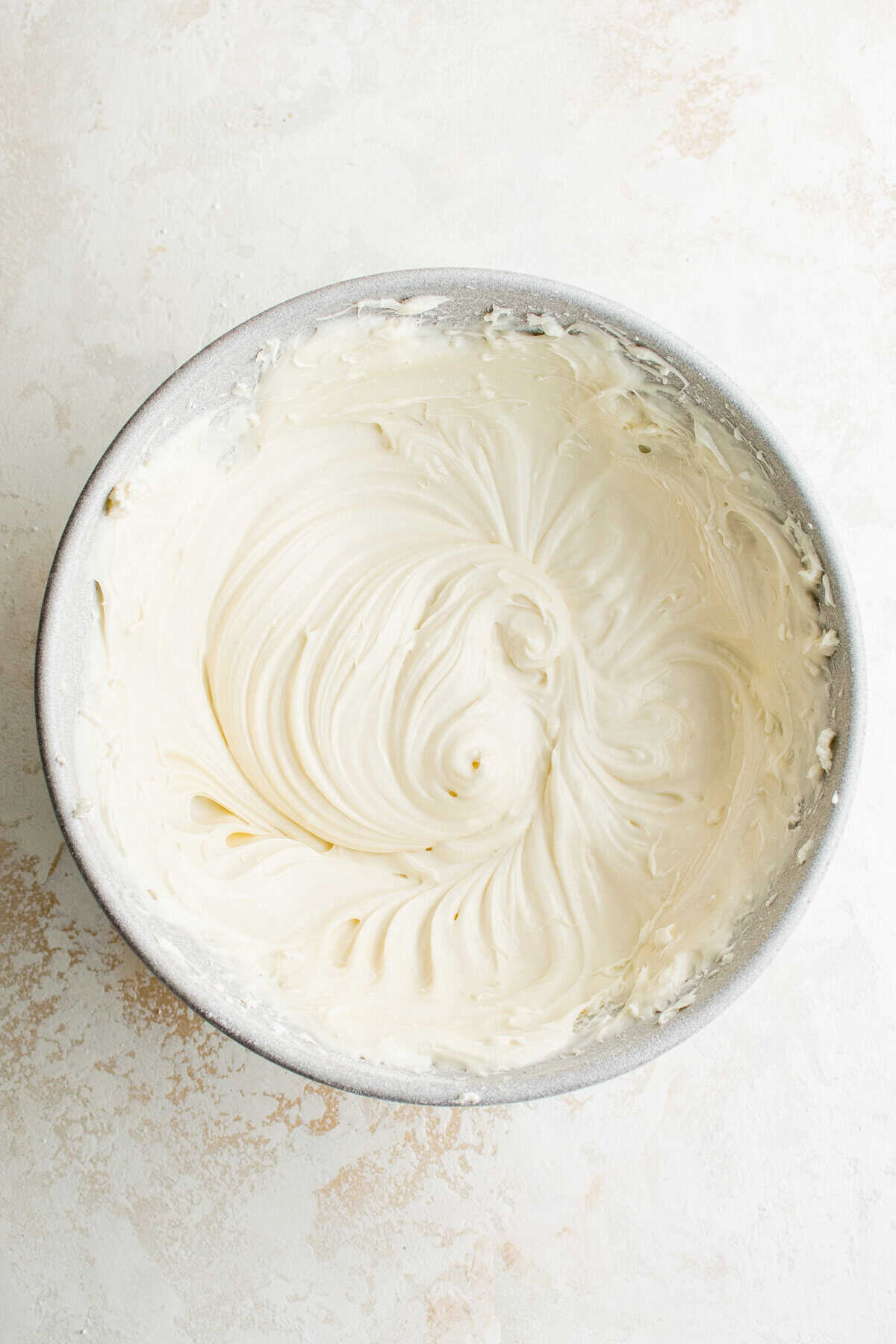 A bowl of cream cheese frosting.