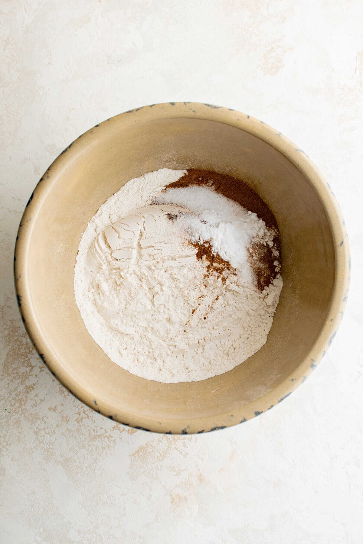 A bowl of flour and other dry ingredients.