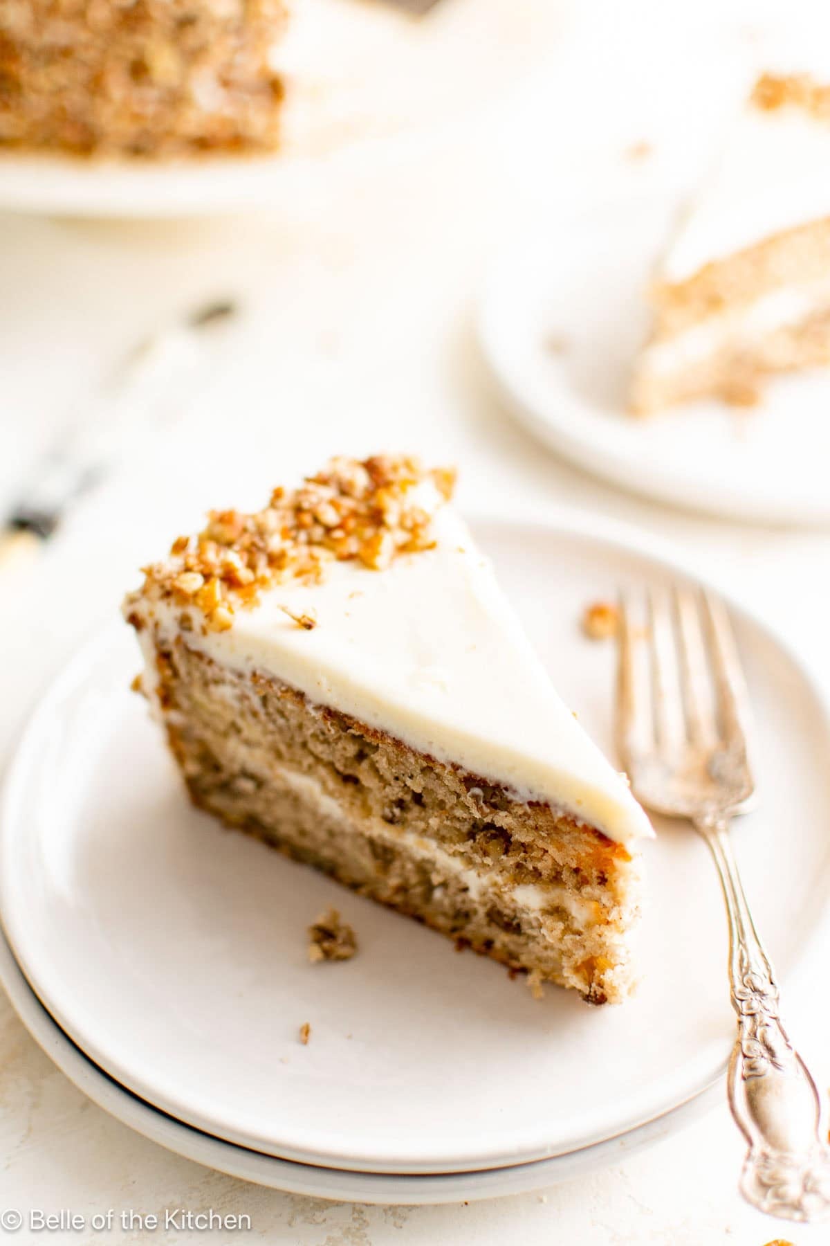 A slice of hummingbird cake on a white plate.