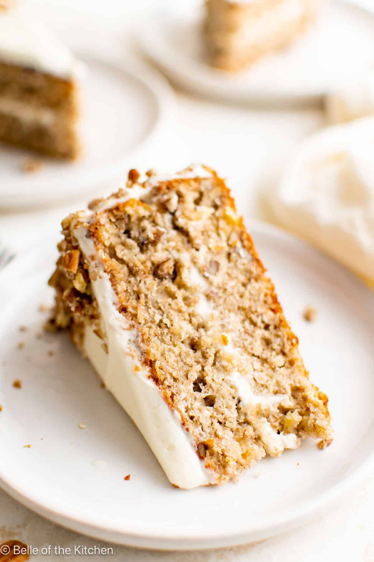 A slice of hummingbird cake on a white plate.