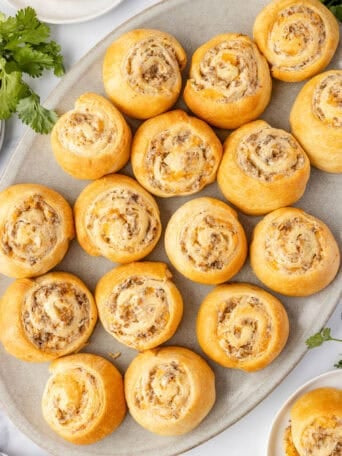 Sausage pinwheels on a white plate.