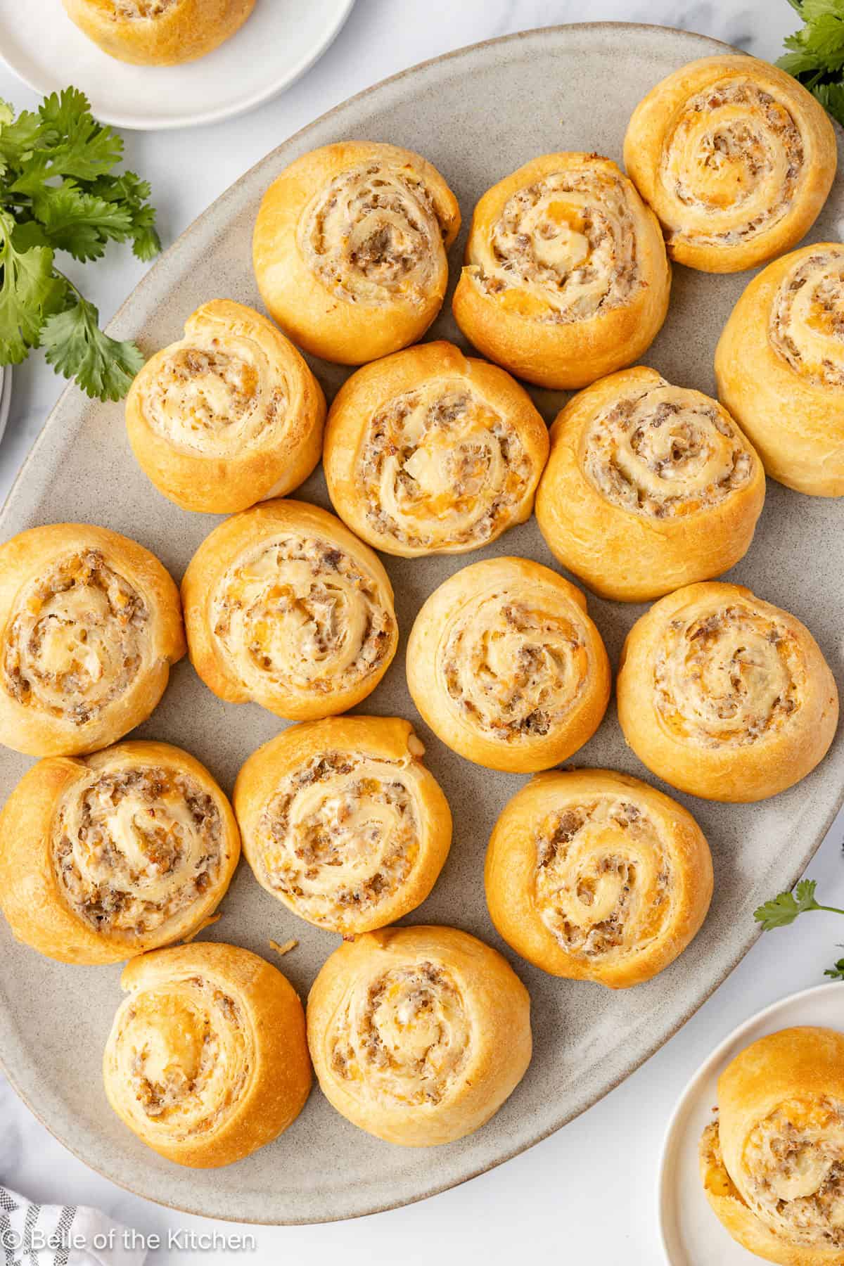 Sausage pinwheels on a white plate.