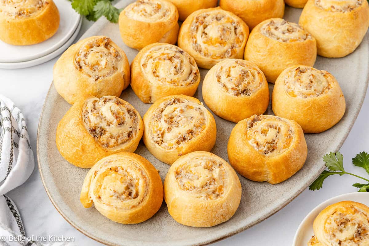 Sausage pinwheels on a white plate.